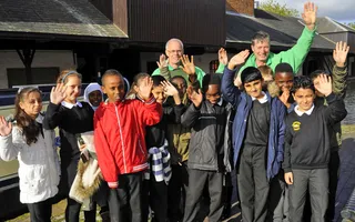 Explorer volunteers with a group of school children