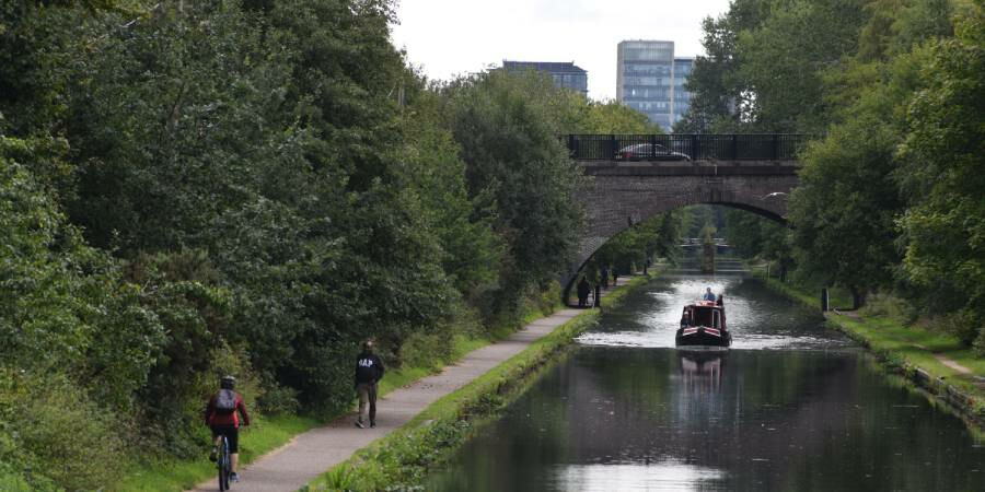 Walkers and cyclists enjoying a towpath walking route in Birmingham