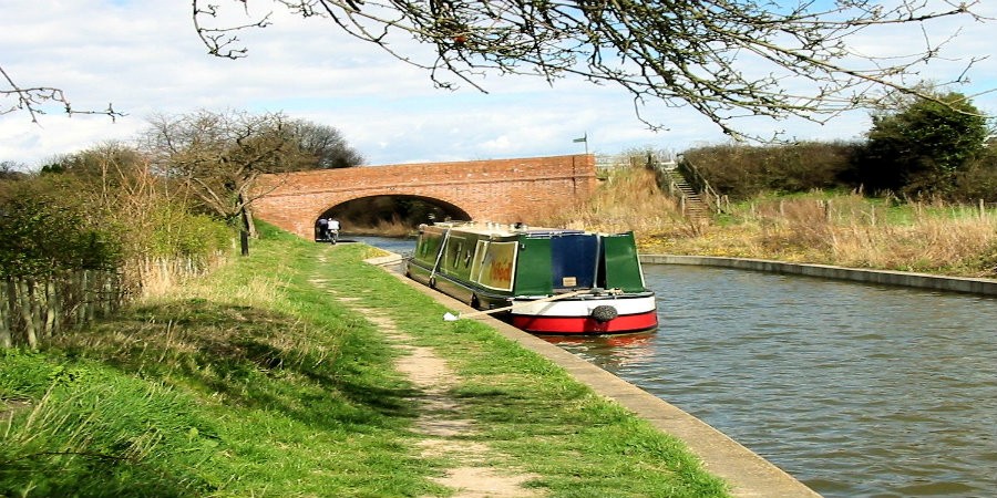 Boat moored in front of Little Tring Bridge on Wendover Arm of Grand Union Canal