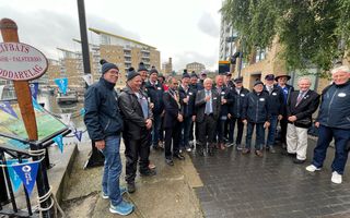 Large group of people standing together on a rainy day