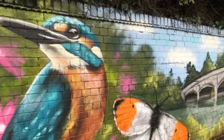 Kingfisher mural on the wall of a canal towpath