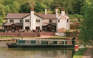 Boat on canal in front of Fowton Locks Inn