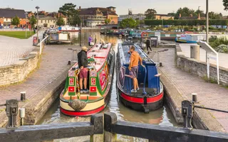 Two narrowboats in a lock to enter Bancroft Basin in Stratford
