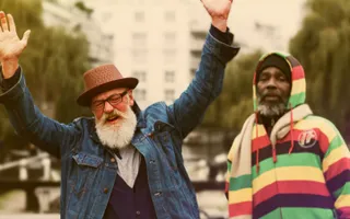 Happy man raising up his hands by the waterways