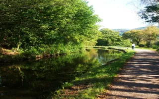Woman walking dog along towpath at Clydach on Swansea Canal