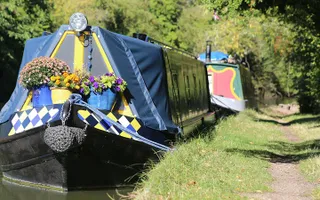 Narrowboat moored in the sun at Milton Keynes on the Grand Union Canal