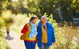 Couple walking by canal in spring