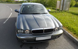 Old grey jaguar car on the road