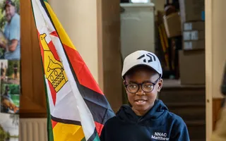 Matthew Taderara, angler holding Zimbabwe flag