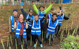 Group of people in blue hi vis jackets cheering