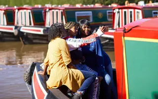 Three women on the back of a boat taking a selfie
