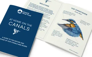 An image of the blue front cover of the canal guide, alongside an example internal page which features a kingfisher