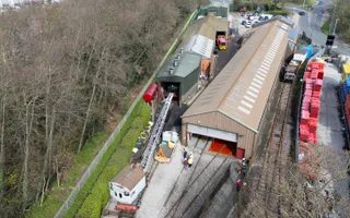 drone shot from above of railway line and warehouse
