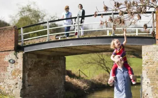 Family walking under a beam bridge