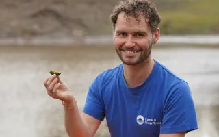 Toddbrook Reservoir: ecologist, Tom, holding moss