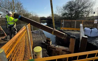 Lock gate beam being installed on a canal