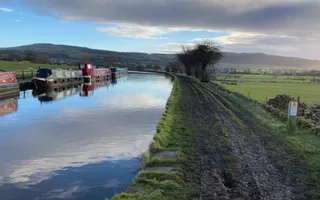 Muddy towpath on a calm canal