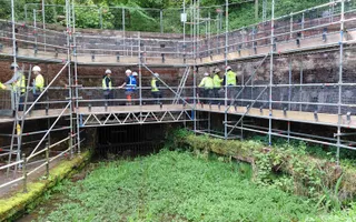 Scaffolding and workers doing restoration work on the bricks