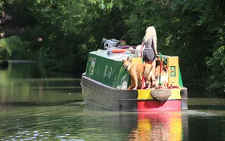 A woman and her dog cruising along the canal