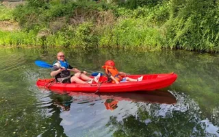 A man and boy kayaking on the Swansea Canal