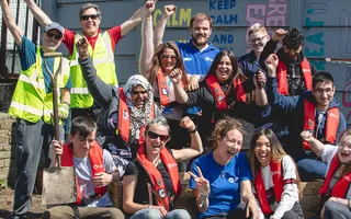 Group shot of young volunteers cheering by the canal in Leeds