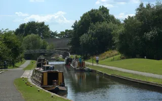 canals moored up on a canal with towpaths on either side on a sunny day