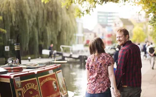 A happy couple walking along the towpath