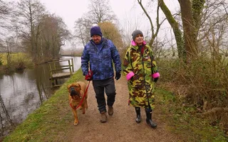 Two walkers and a dog by the towpath at Goytre on the Monmouthshire & Brecon Canal