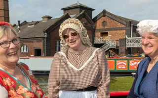 3 volunteers in traditional canal town costume at Ellesmere Port