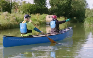 Two people in a canoe on a sunny day