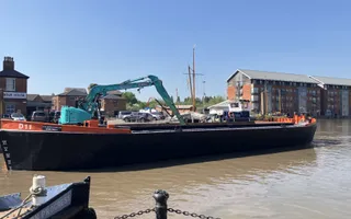Boat on water with digger on top