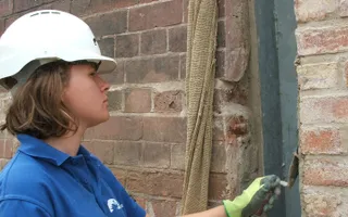 Iona helping to preserve brickwork using tools