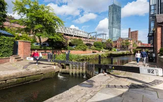 Wide shot of city, byt the canal