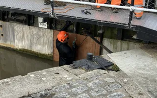Mid shot of a worker making repairs to a lock gate