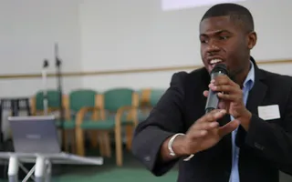 Louis speaking at an event