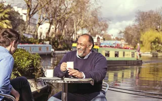 Man enjoying coffee by the canal