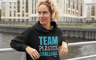 A lady wearing a hoody by the canal