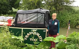Waterways Chaplain the Rev. Pat Willis stands by her boat