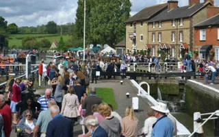 Crowds gather around a lock for an event at Stoke Bruerne