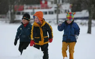 Kids playing in the snow by canal