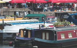 Array of colourful boats lines up in basin