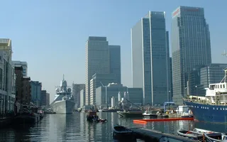 Variety of boats moored in front of buildings in London Docklands