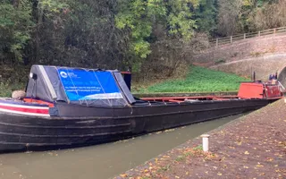 An old narrowboat passing through a tunnel