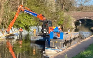 Digger on a float dredging the canal