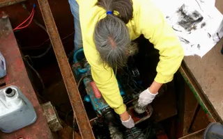 Debbi changing the fuel filter on her boat engine