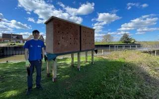 Man in Canal & River Trust t-shirt stands by canal