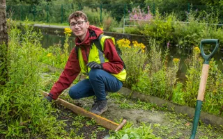 Young person planting green spaces along our waterways