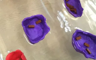 Plasticine boats filled with miniature bricks