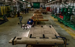 Inside a workshop showing a carpenter working on a lock gate