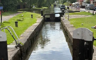 A shot looking down a canal with lock gates across in the centre